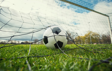 Custom blinds with your photo Close up of a soccer ball enters the gate and hits the net, goal concept. Football championship background, spring outdoors tournaments. Healthy sports activity and games.